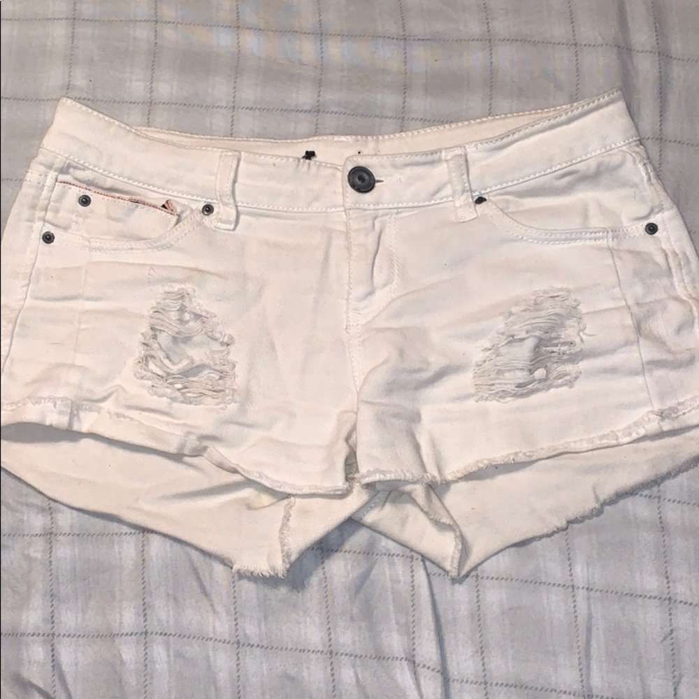 White ripped shorts